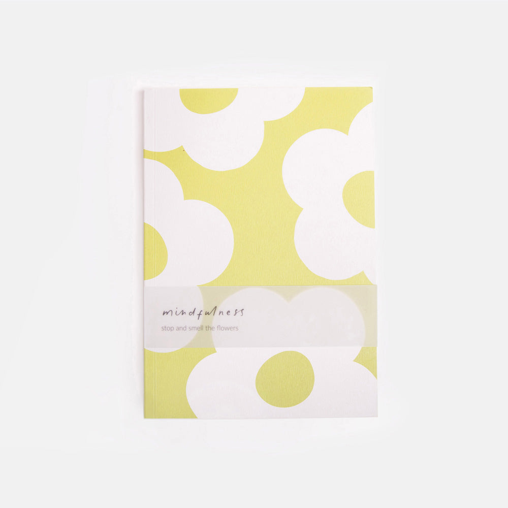Notebook with green and white floral pattern on a white background