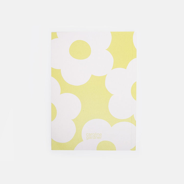 Notebook with white floral pattern on a green background
