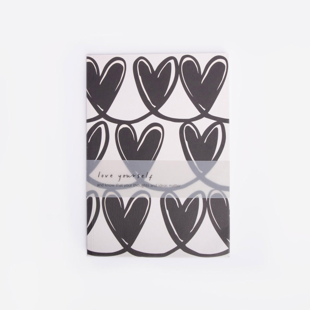 Notebook with black heart pattern on a white background