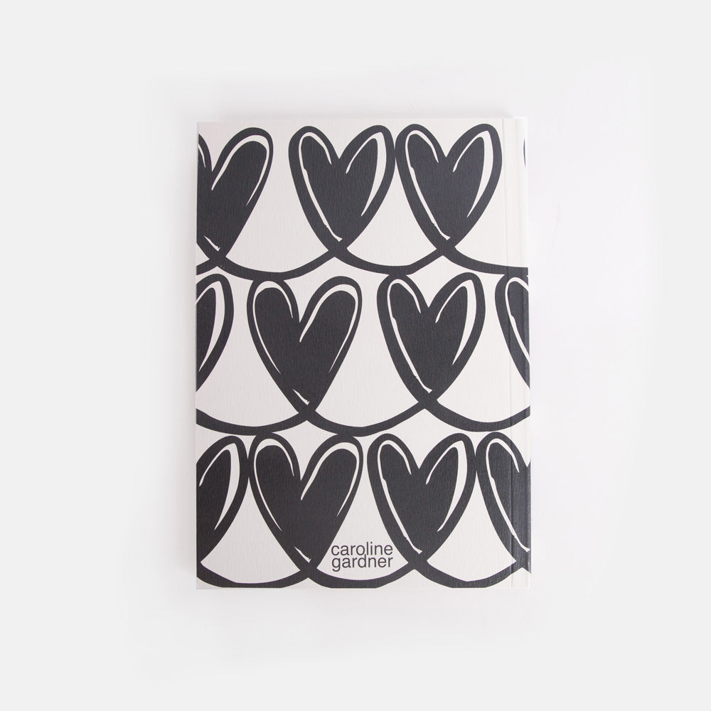 Notebook with black heart pattern on a white background