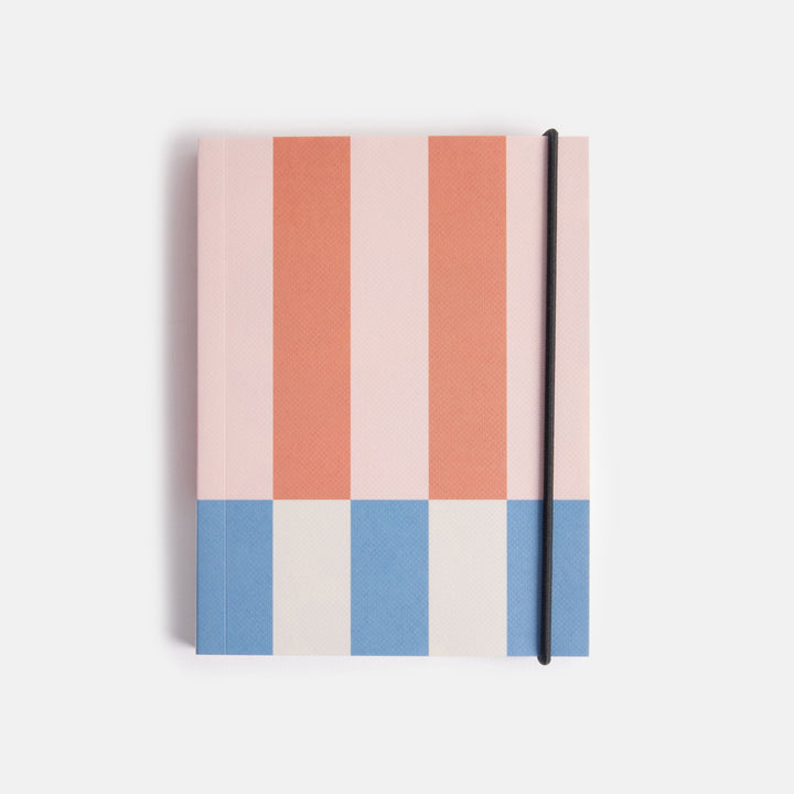 small chunky soft cover notebook with elastic strap closure and colourful offset stripe design