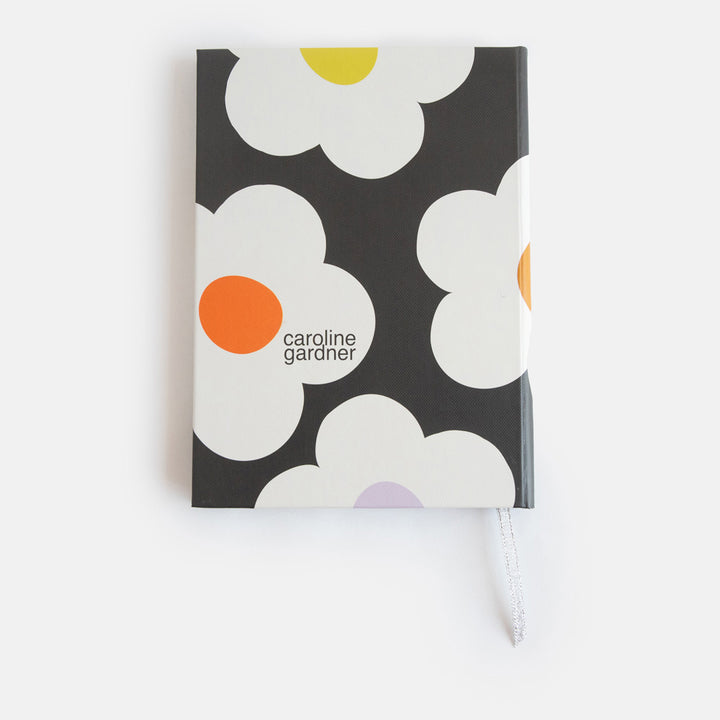 slim casebound hardcover notebook with cream flowers over a charcoal background design
