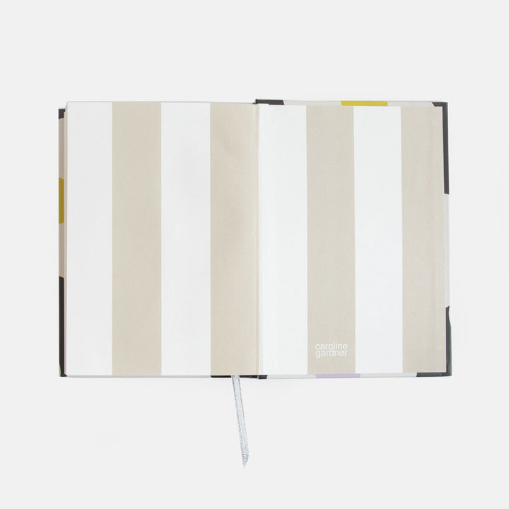 slim casebound hardcover notebook with cream and white striped lining and lined pages