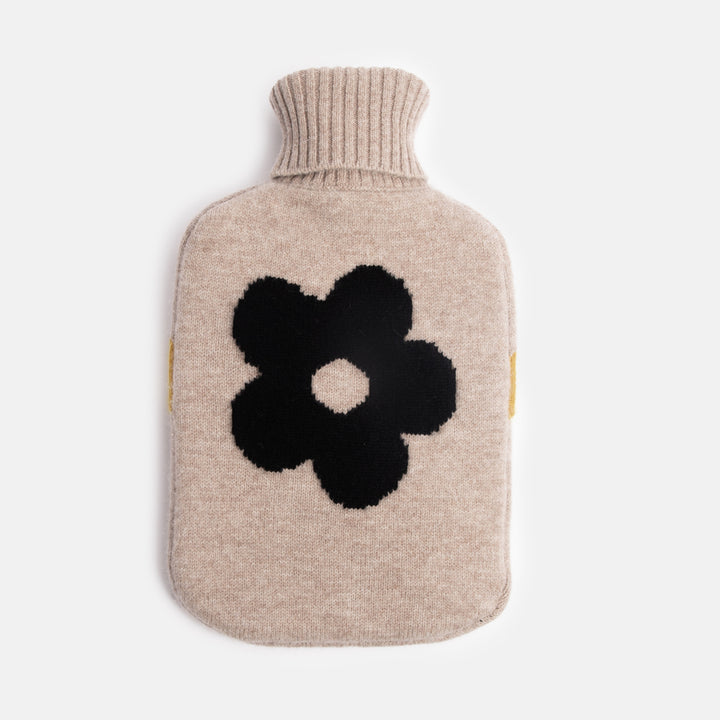 pure merino hot water bottle in charcoal flower design on an oat coloured base with yellow trim