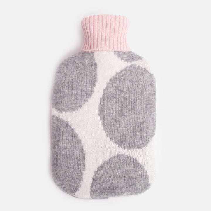 pure merino hot water bottle featuring a grey spot design on a cream base with pale pink and burnt orange trims