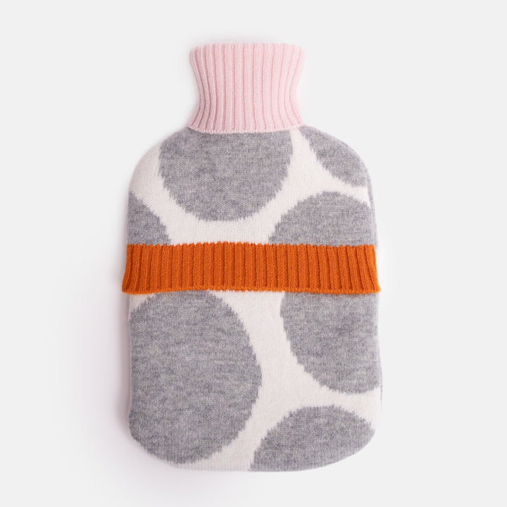 pure merino hot water bottle featuring a grey spot design on a cream base with pale pink and burnt orange trims