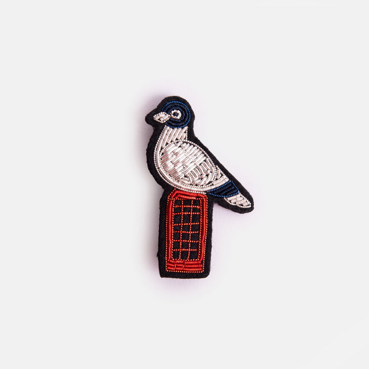 bird perched on a red phone box beaded brooch