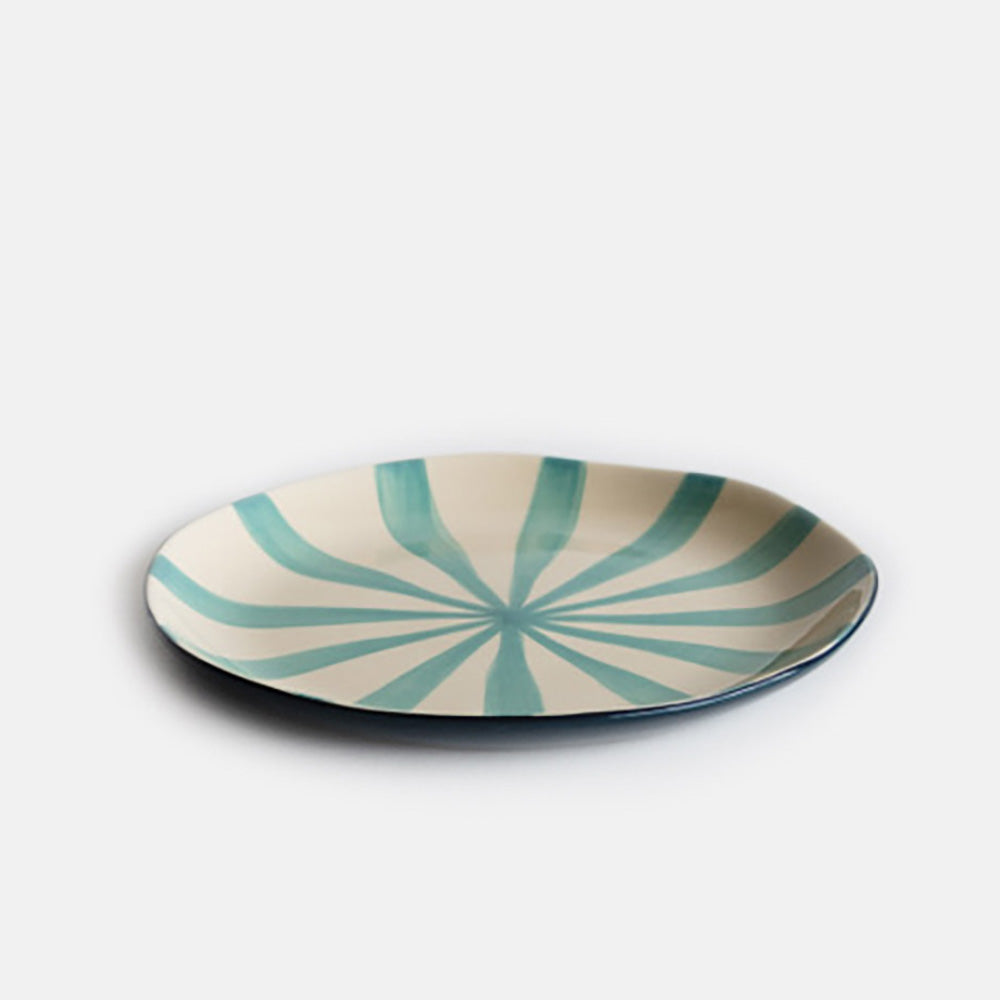 hand made and painted ceramic plate with dark blue under and light blue sunray stripe inner