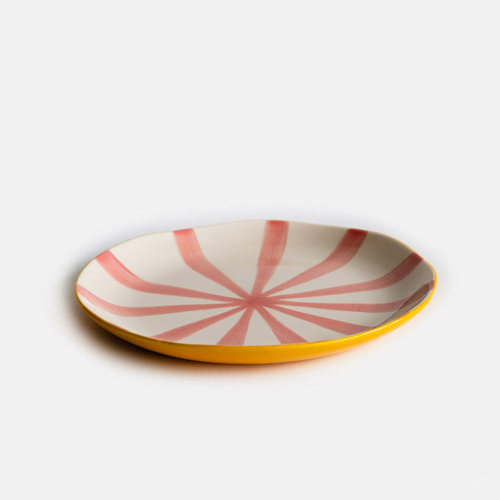 hand made and painted ceramic dinner plate with yellow underside and pink striped inner