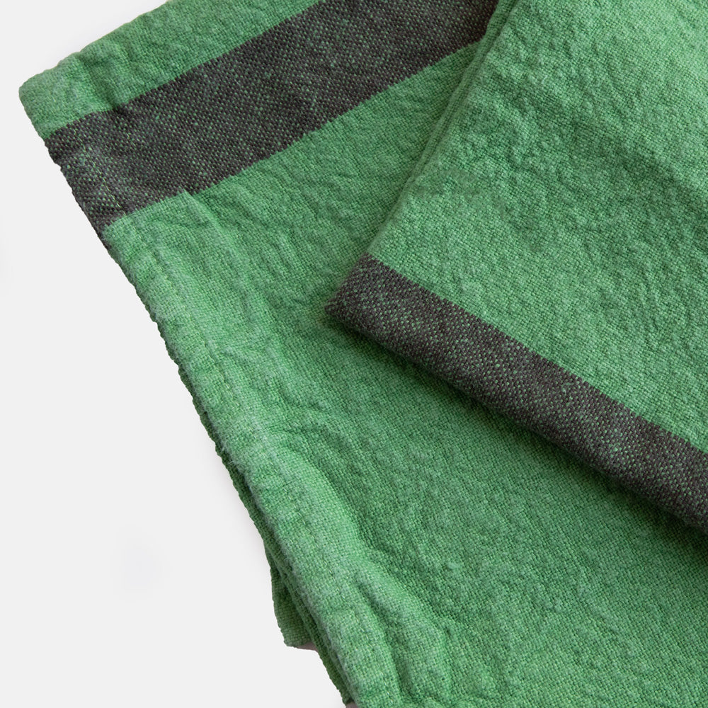 set of 2 green washed linen placemats with dark central stripe