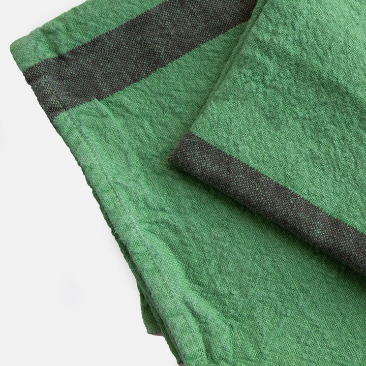 set of 2 green washed linen placemats with dark central stripe