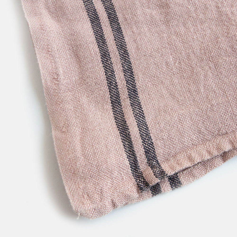 light pink washed linen tea towel with two dark stripes at either end