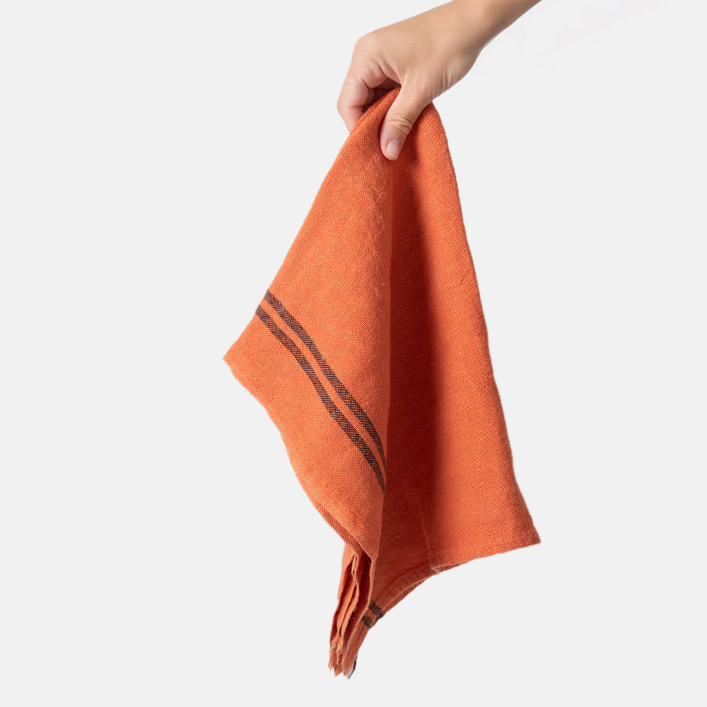 orange linen tea towel with 2 dark stripes at either end