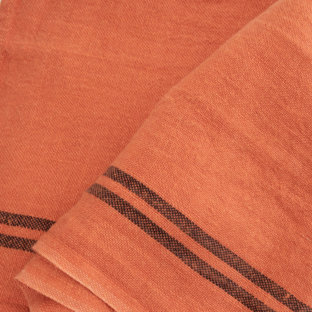 orange linen tea towel with 2 dark stripes at either end