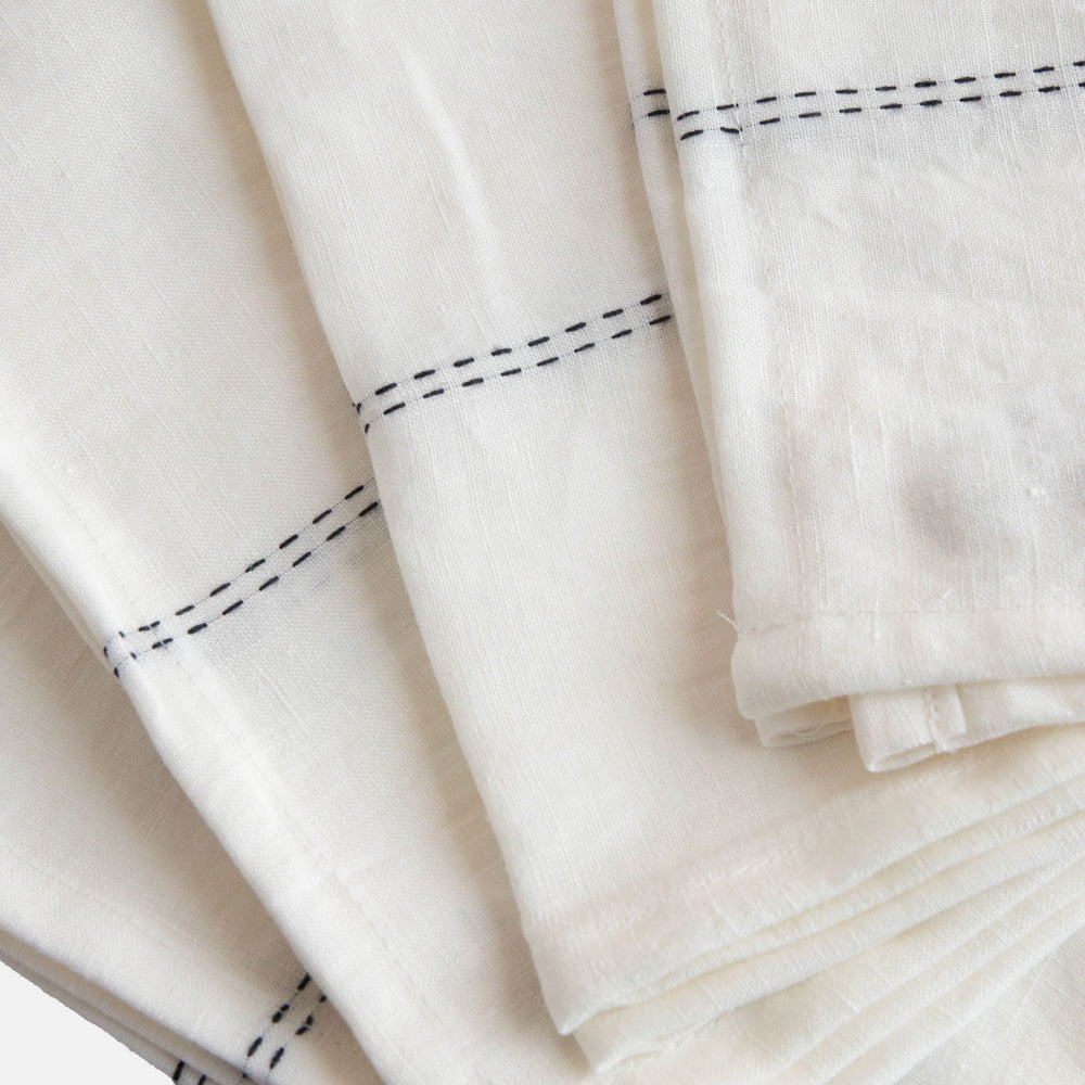 set of 4 white linen napkins with black stitch detailing 