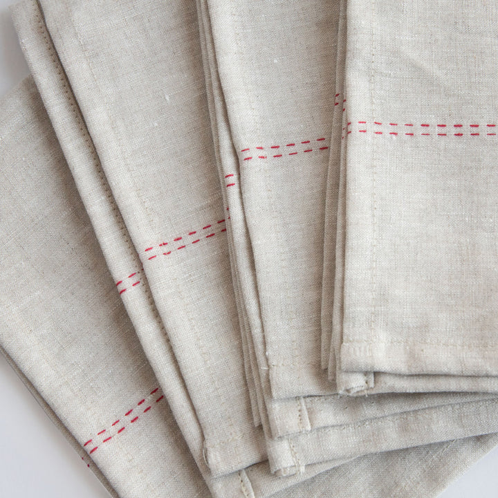 set of 4 natural linen napkins with red stitch detailing 
