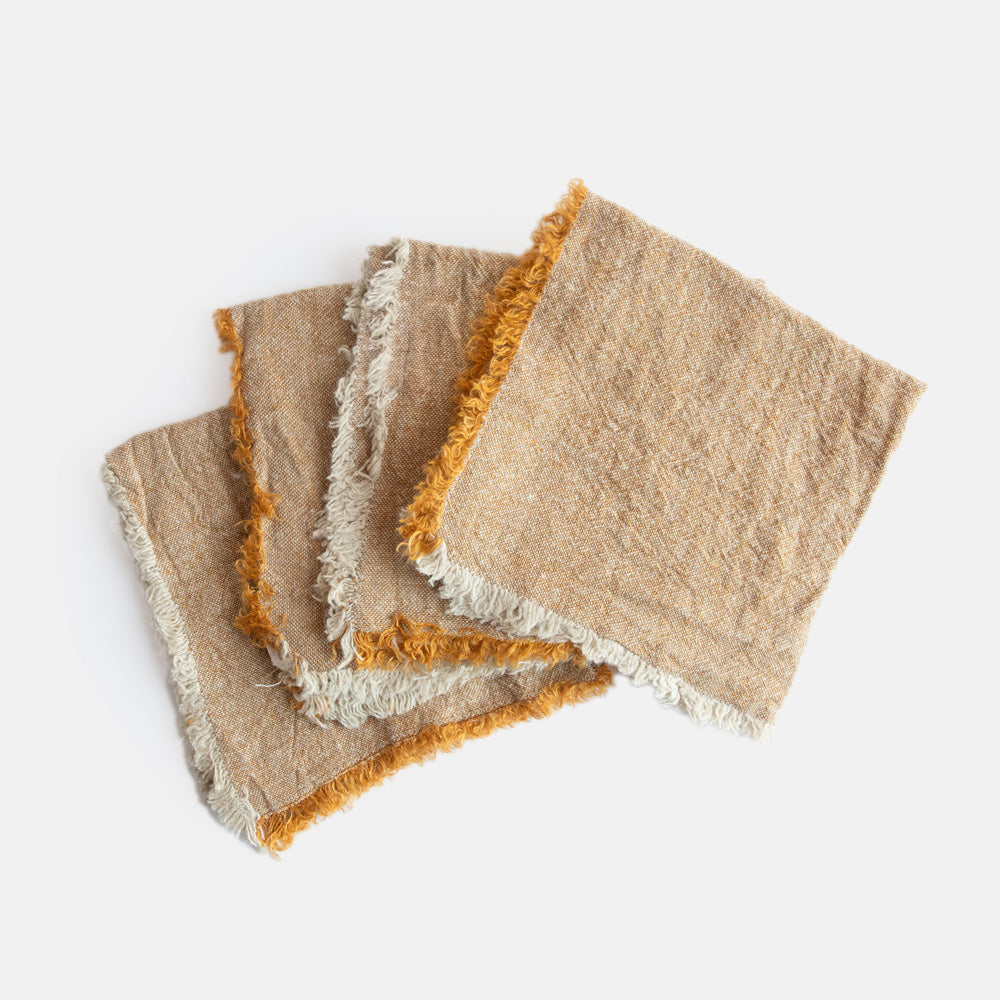 set of 4 ochre yellow textured linen napkins with tasselled edges
