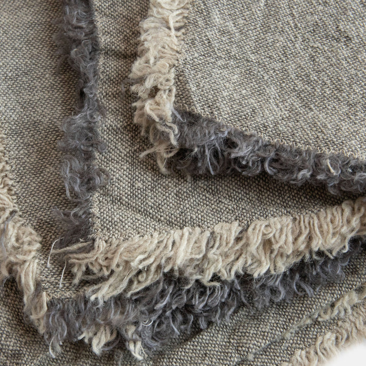set of 4 graphite grey linen napkins with tasselled edges