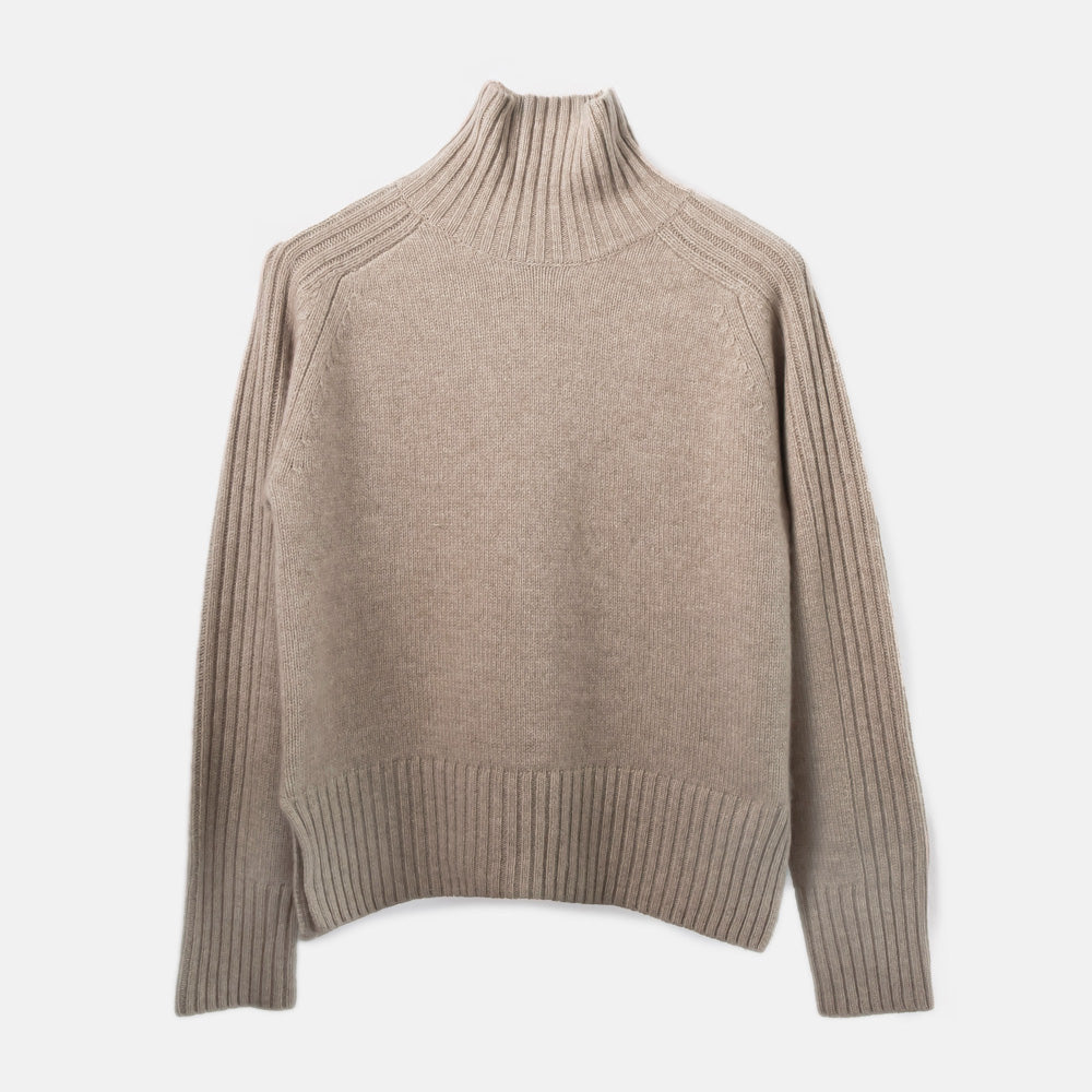 Beige turtleneck sweater on a light gray background