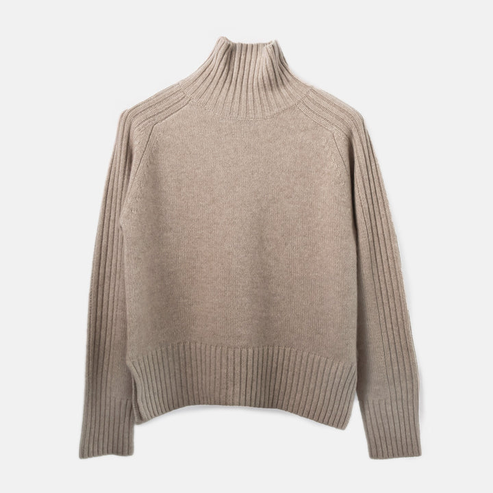 Beige turtleneck sweater on a light gray background