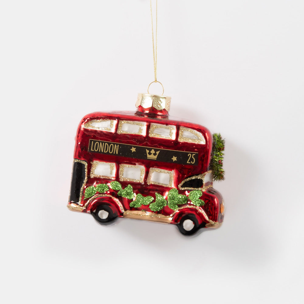 red double decker london bus glass hanging christmas decoration with green glittery leaves on the side and green wreath on the front