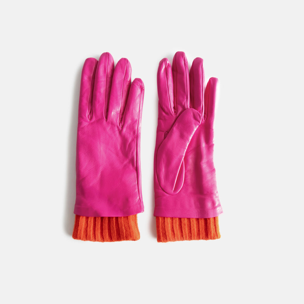 pair of women's leather gloves in bright pink with red ribbed wrist cuff