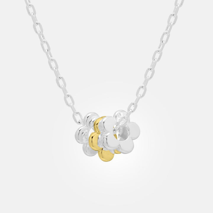 silver plate link chain necklace with three flower shaped charms, two in silver and one in gold