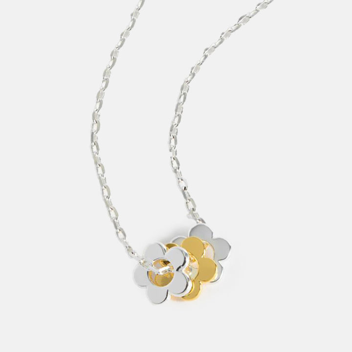 silver plate link chain necklace with three flower shaped charms, two in silver and one in gold