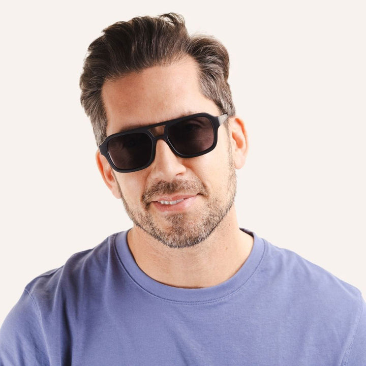 man wearing black double bridge modern aviator style sunglasses with grey lenses