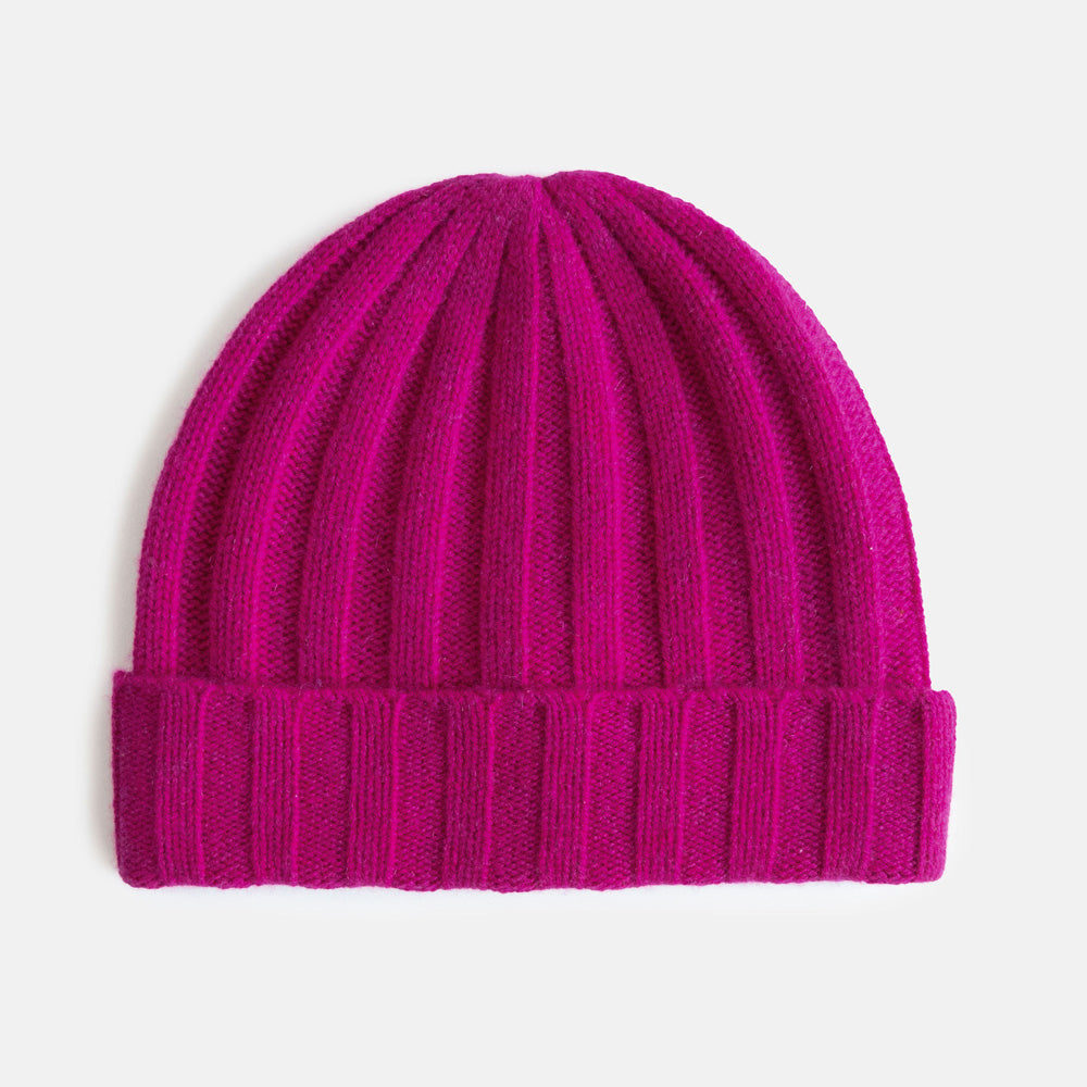 Pink knit wide rib beanie hat on a light grey background