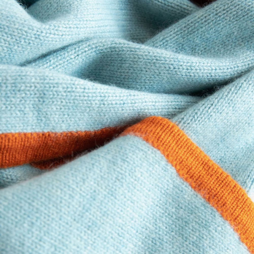 women's cashmere neck scarf in light blue with orange trim