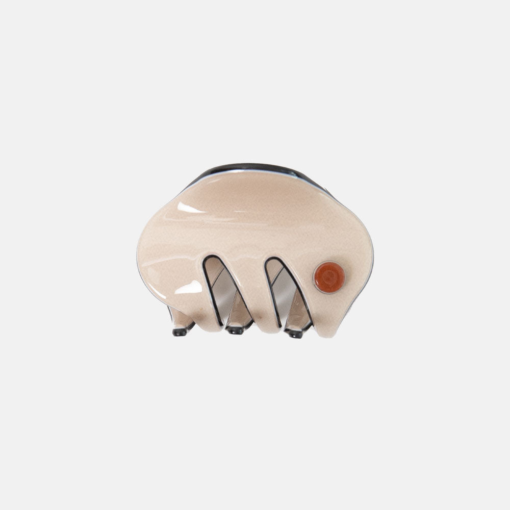 Beige hair clip with a brown button on a white background