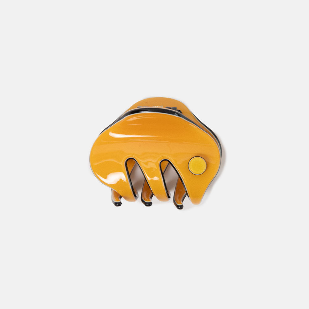 Yellow hair clip on a white background