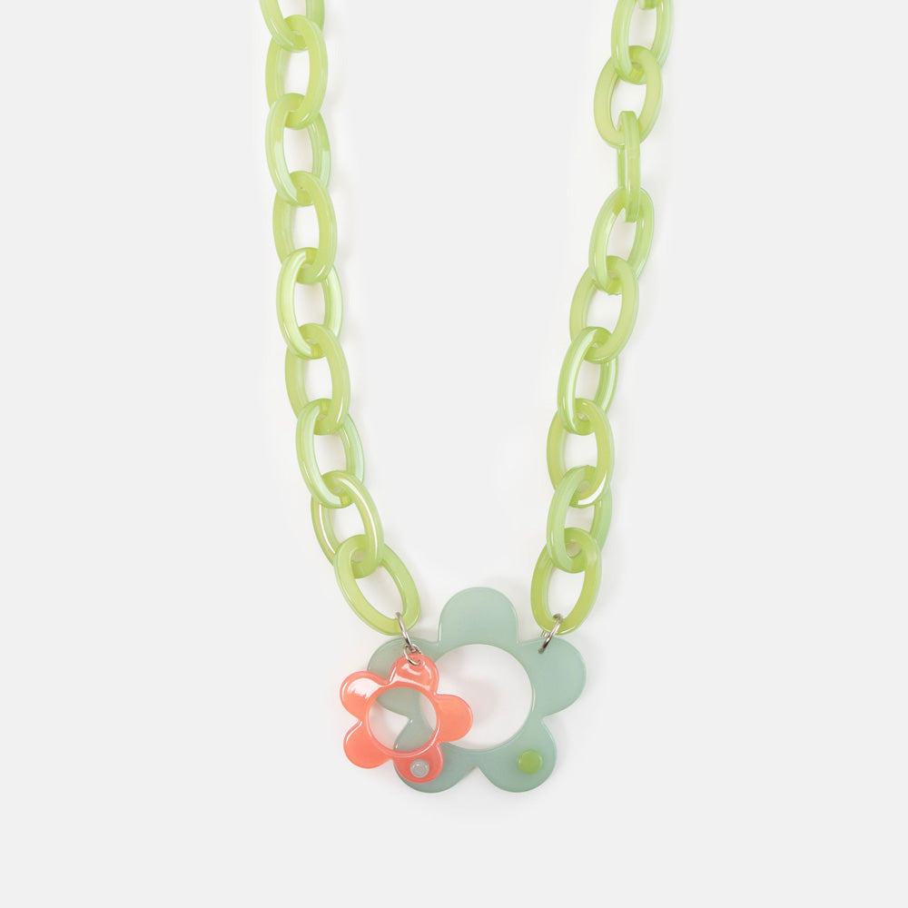 Necklace with a floral pendant on a light green chain against a white background