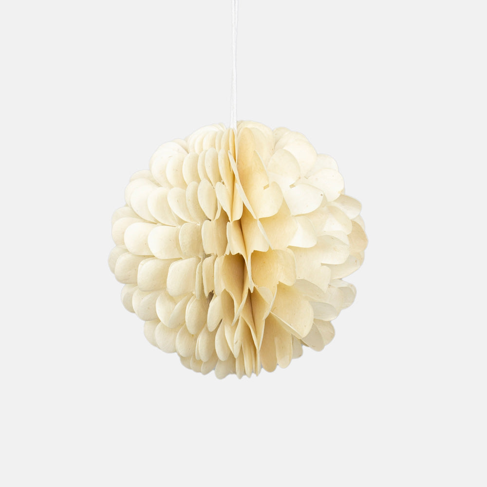 Cream-colored paper flower hanging Christmas decoration against a white background