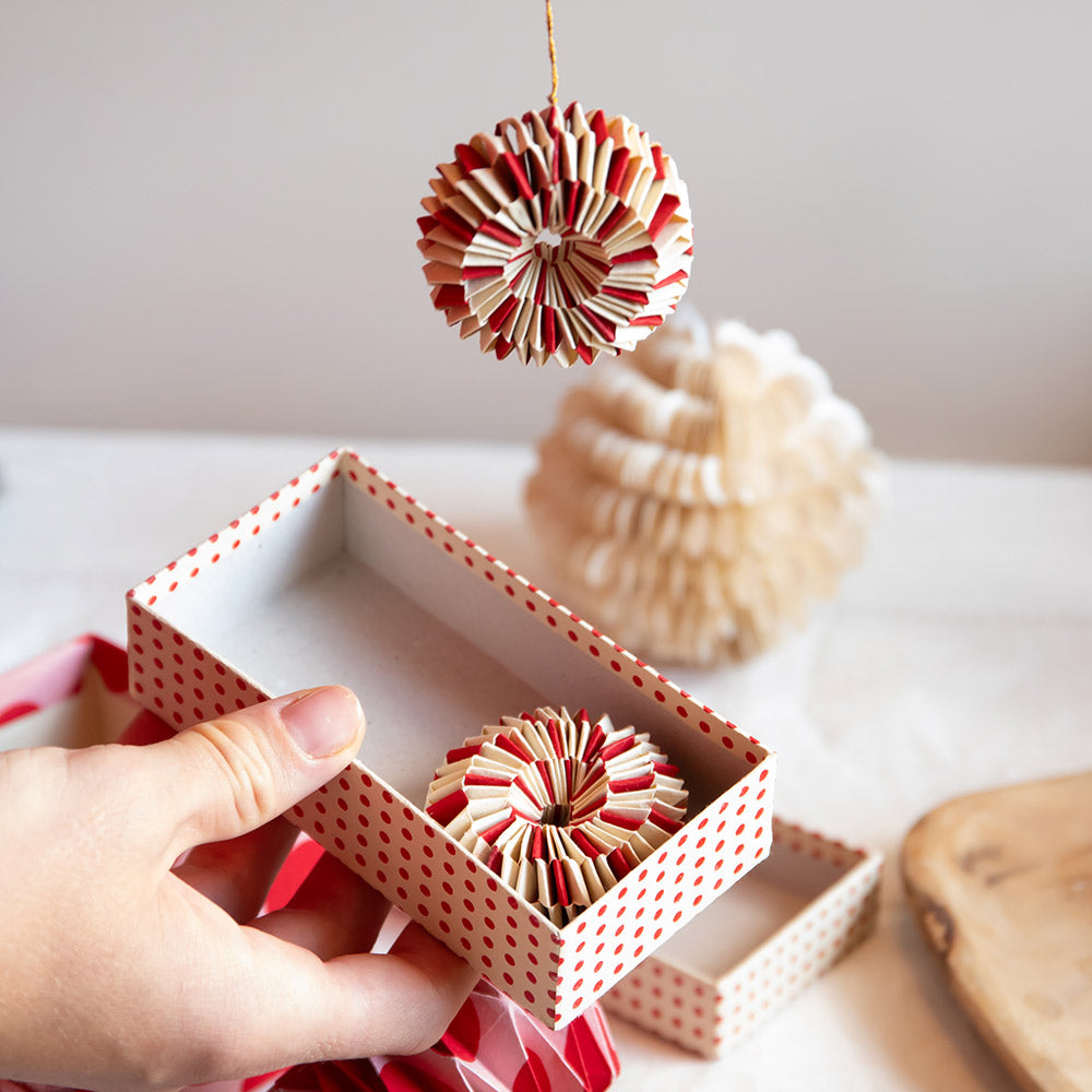 set of 2 red and white paper wheel Christmas decorations in a presentation box 
