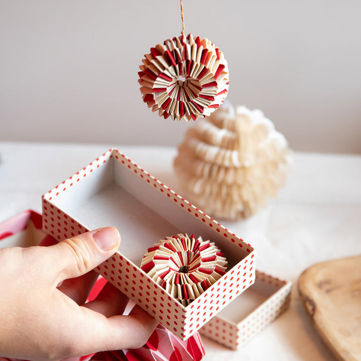 set of 2 red and white paper wheel Christmas decorations in a presentation box 