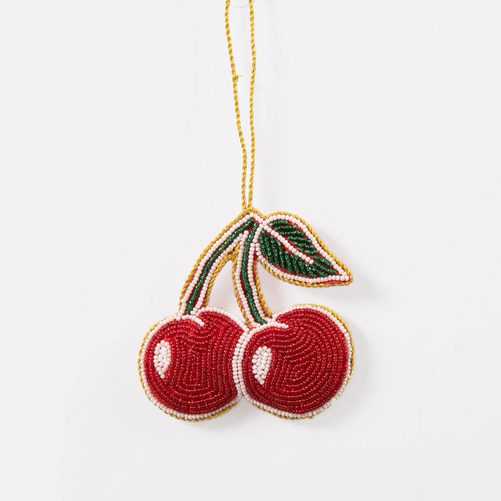 Beaded red cherries hanging Christmas tree decoration on a white background