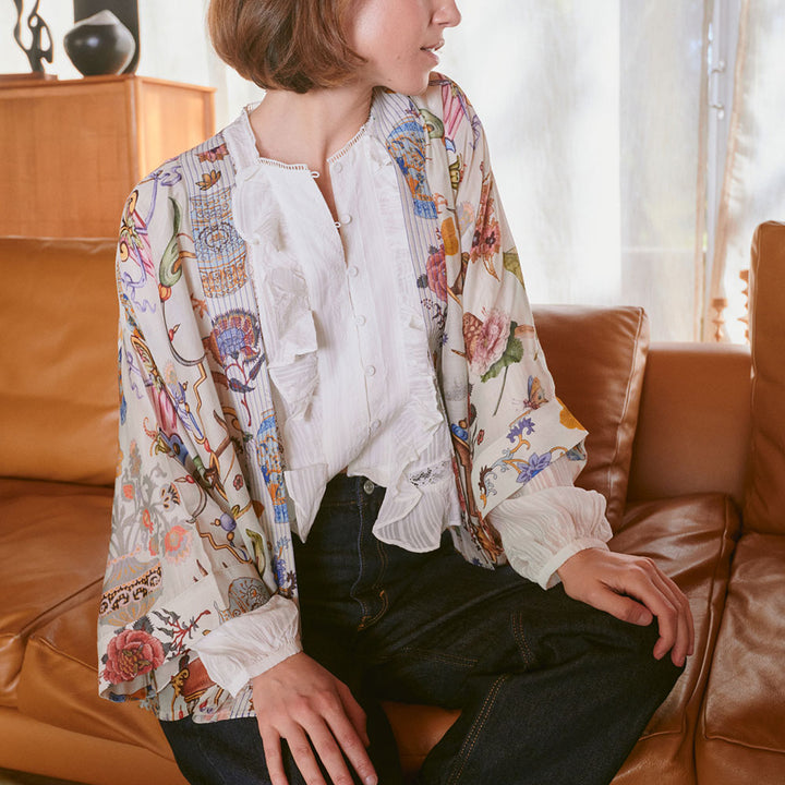 women's short kimono featuring a design of assorted objects, animals & flowers on an ivory base