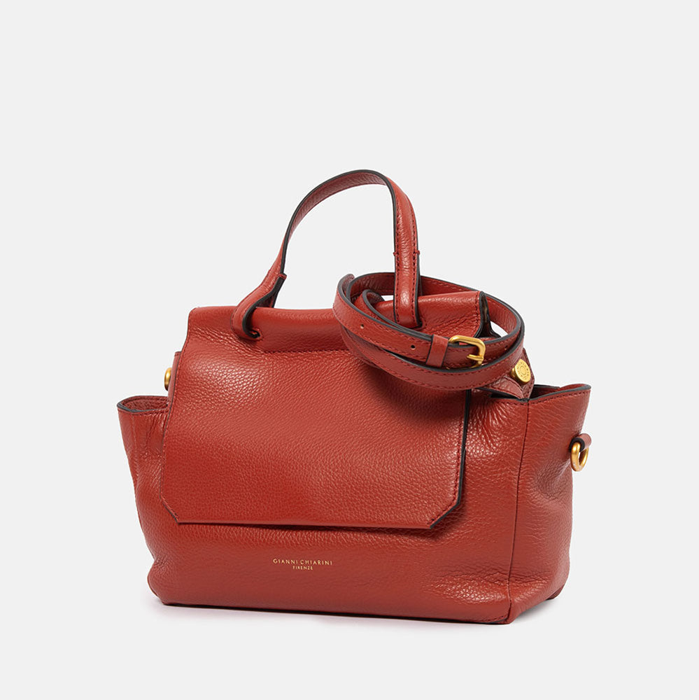 dark red pebbled leather handbag with top shoulder handle and matching leather crossbody strap