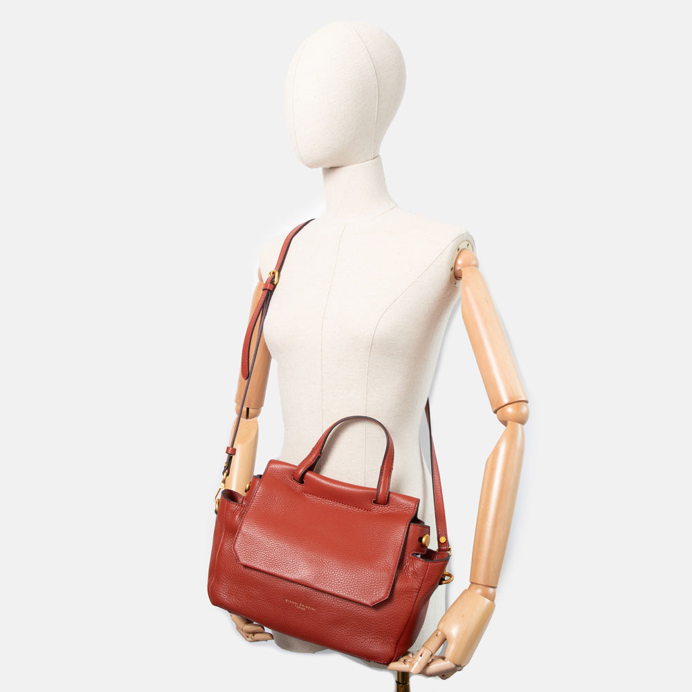 dark red pebbled leather handbag with top shoulder handle and matching leather crossbody strap