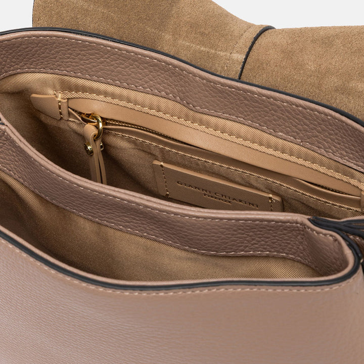 dove grey pebbled leather saddle handbag with canvas lined internal compartment