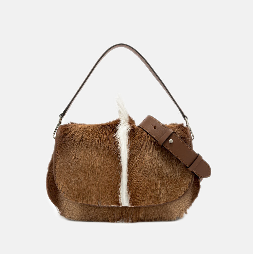 brown & cream springbok leather baguette shaped saddle bag with brown grab handle and crossbody strap