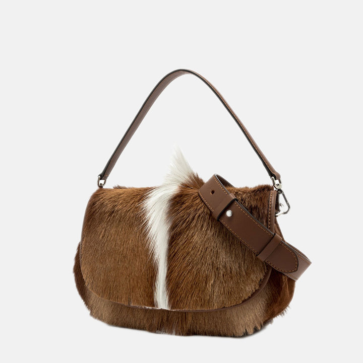 brown & cream springbok leather baguette shaped saddle bag with brown grab handle and crossbody strap