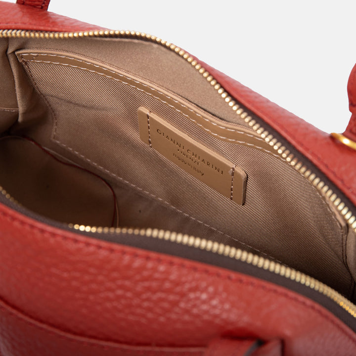 brick red pebbled leather handbag with canvas lined internal compartment