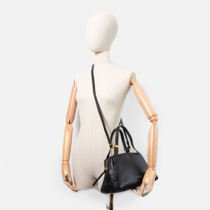 black pebbled leather handbag with gold hardware and grab handles and detachable crossbody straps