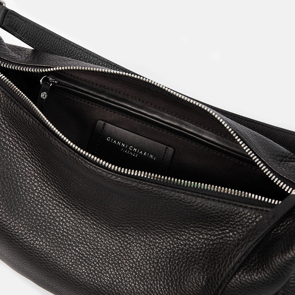 black pebbled leather sling bag with leather shoulder strap and webbing crossbody strap