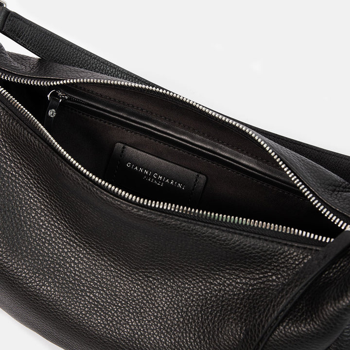 black pebbled leather sling bag with leather shoulder strap and webbing crossbody strap
