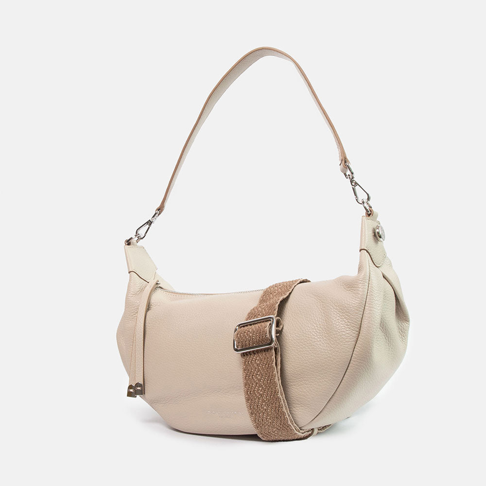 light grey pebbled leather sling bag with leather shoulder strap and webbing crossbody strap