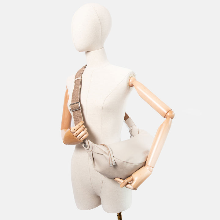 light grey pebbled leather sling bag with  webbing crossbody strap